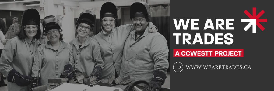 five women in welding gear smile at camera