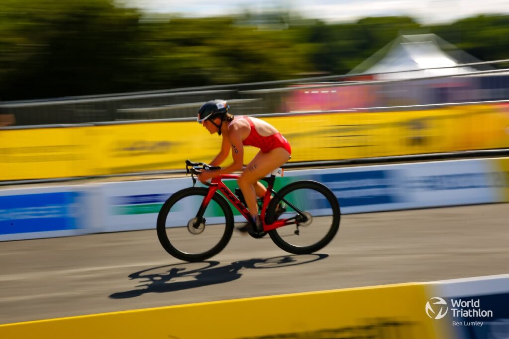 Dominika Jamnicky rides a bike on a roadway.