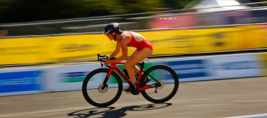 Dominika Jamnicky rides a bike on a roadway.