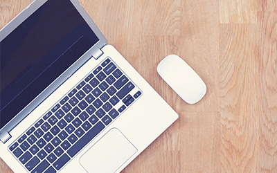 Laptop and mouse to represent Enrolment Services