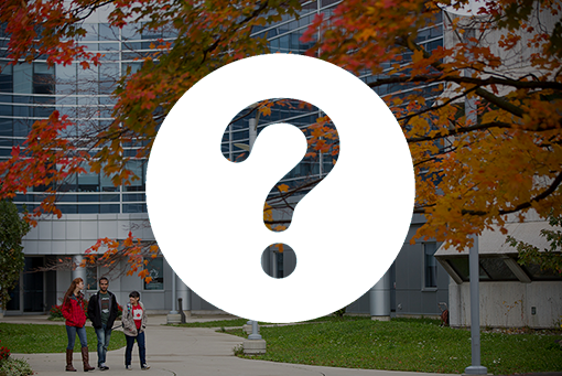 Three students walking in front of the Summerlee Science Complex 
with an icon of a question mark