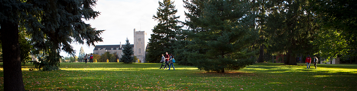 Students walking through Johnston Green, with Johnston Hall in the background