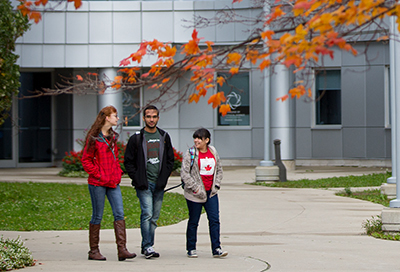 Three students walking by the Summerlee Science Complex
