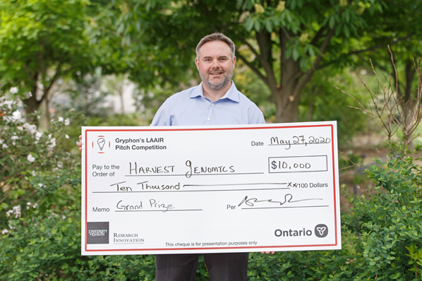 Chris Grainger, CEO of Harvest Genomics, pictures with Grand Prize cheque of $10,000