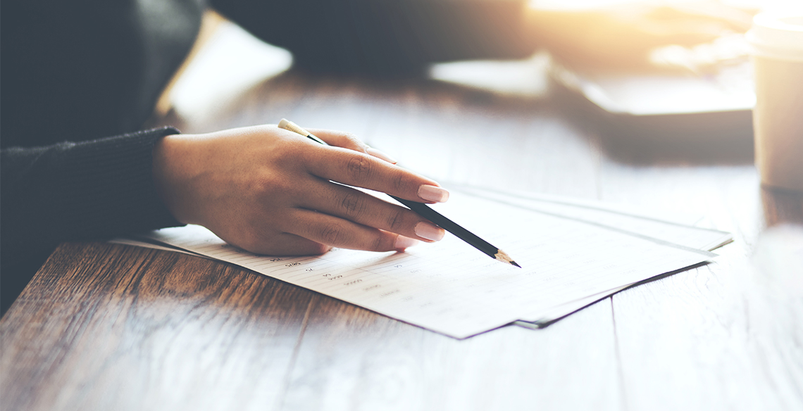 Business person writing on paper