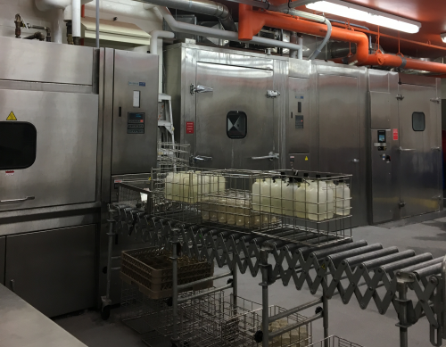 Cage washing facility containing large rectangular metal cleaning units