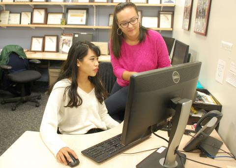 A photo of SPARK writer Marika Li (left) conferring with senior SPARK writer Alaina Osborne (right) about the 150 innovation project