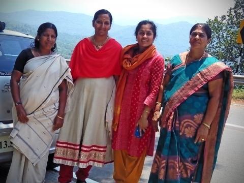 Photo of four women in colourful saris