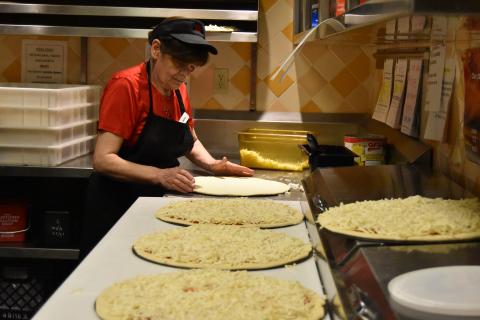 Photo of a woman making pizza