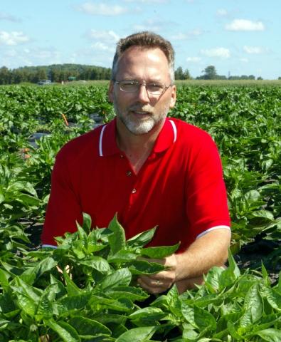 Photo of John Zandstra in a field.