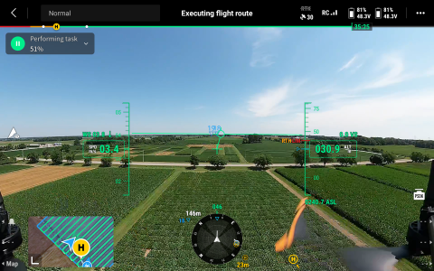A view from the screen of the drone, showing a field and data.