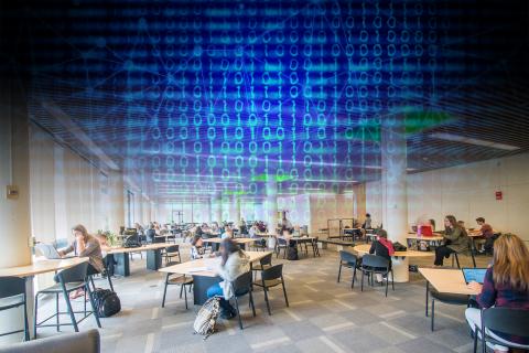 Photo of people sitting in the library with 'data' floating in the air