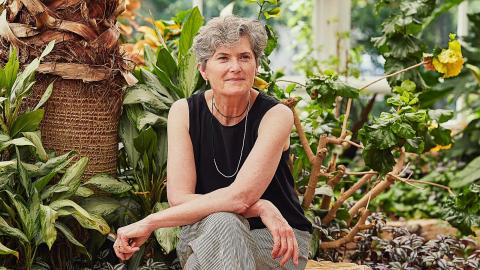 Beth Parker sitting in front of greenery