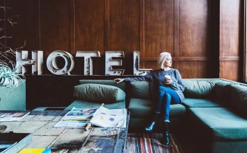 A woman sitting on a couch in a hotel