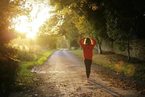 A girl walking along a path in a wooded area