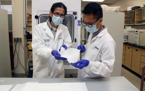 A professor and a grad student displaying the mask filter material