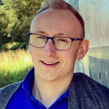A headshot of Adam Davies.