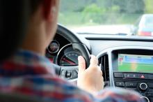 A person sitting at the wheel of a car