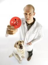 Scott Weese posing with a dog.