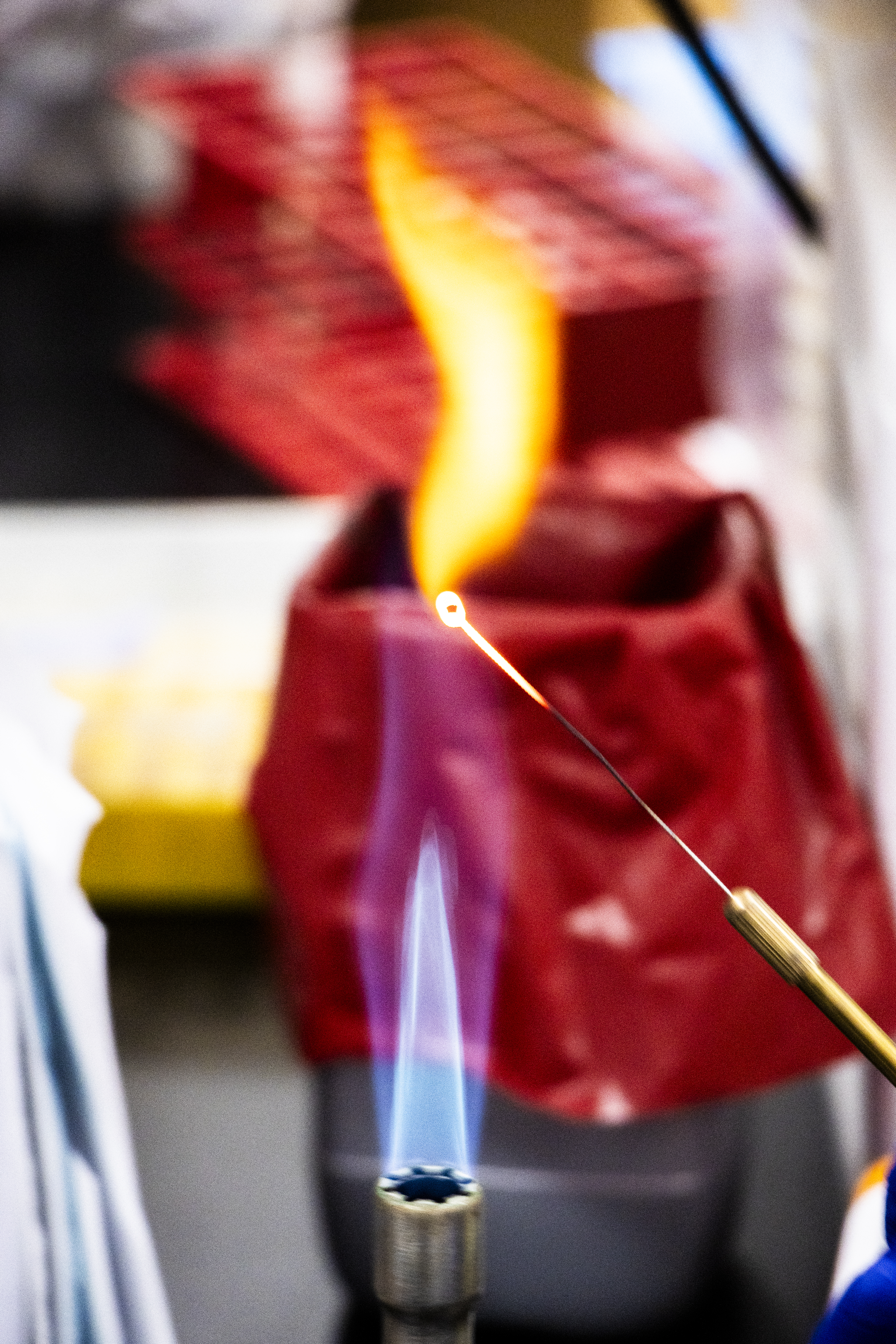 A metal tool being sterilized over an open flame.
