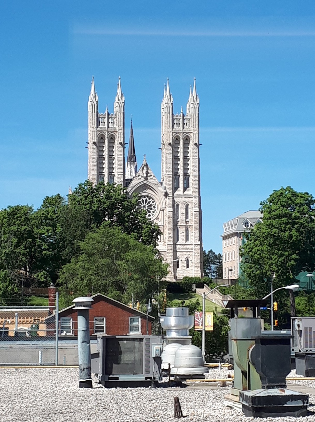 View from the window of an office space. We see the Guelph basilica on a blue sky.