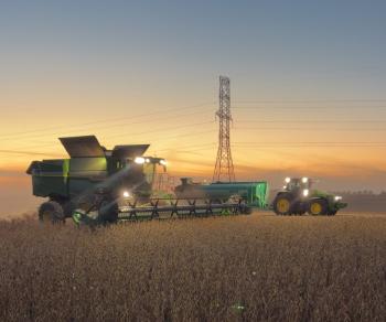 A tractor with a transformer in the background at dusk.