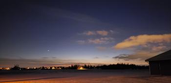 Outside the Arkell Poultry facility at night. There is snow on the ground, a dark blue sky and white clouds in the distance.