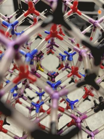 Close-up of a detailed model of a crystal lattice, built with sticks to illustrate the atomic arrangement in a solid. 