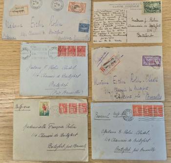 A group of envelopes and a post card addressed in French to Madame Rolin-Cladel, 114 Chausée de Boitsfort, (Près Bruxelles), Boitsfort, where she lived in in Brussels, Belgium. One letter is addressed to Mademoiselle Françoise Rolin at the same address. The letters are placed on a wooden table and each one has a unique grouping of postal and time stamps, also in French.