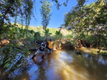 A celebratory moment between a UofG student and a community member in a river in Ankarafantsika National Park, Madagascar