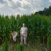 A woman standing in a crop field.