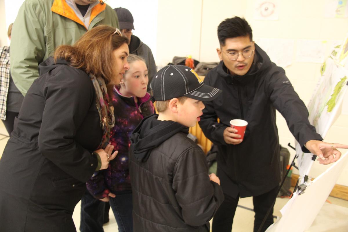 Students and parents looking at design work at Open House