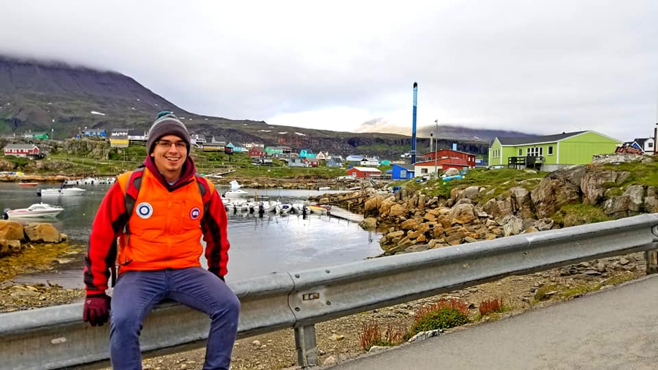 Brady Reid in front of remote village