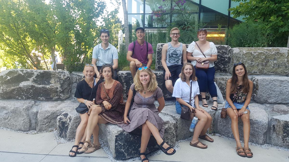 Students sitting on rocks