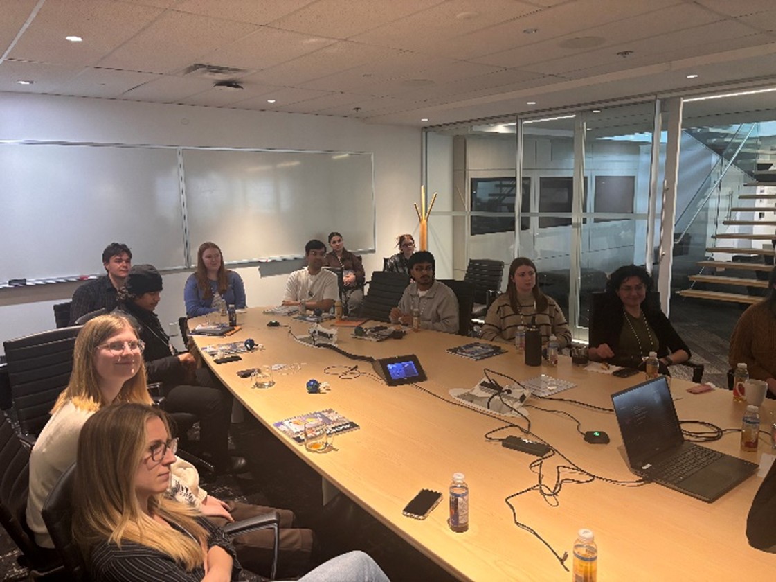 Students sitting around a boardroom table at Esri Canada
