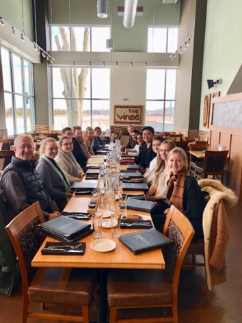 Long row table of students sitting down for meal