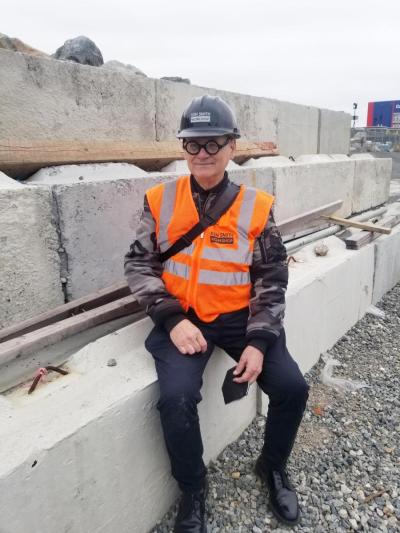 Ken Smith at a construction site the hard helmet on surrounded by cement blocks