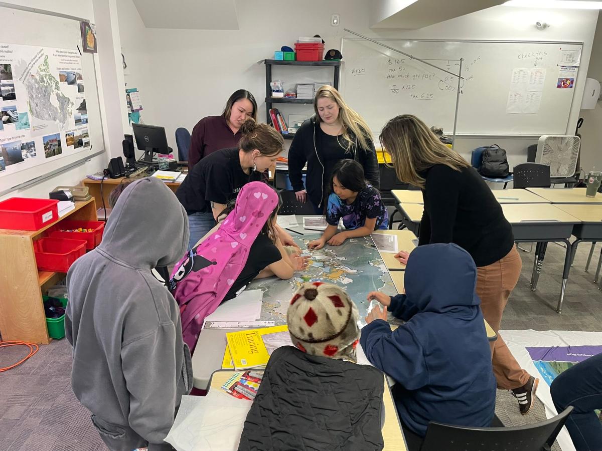 Elementary students looking at map