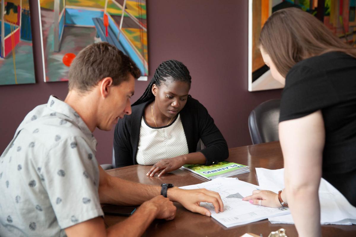 Three students working together on a project at a table