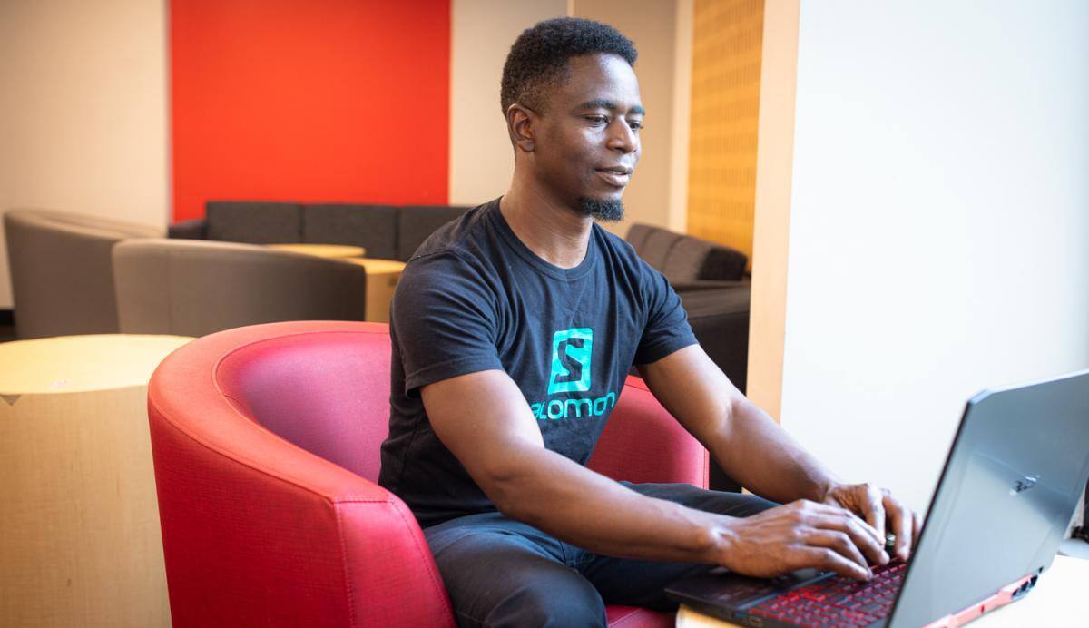 student sitting down with laptop