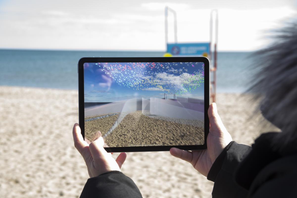 "WE[AR]" Interactive Augment Reality Art Installation.  View of  beach installation from tablet 