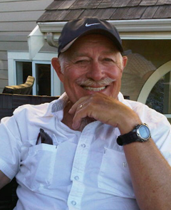 Gerry Fitzsimmons sitting on a deck outdoors