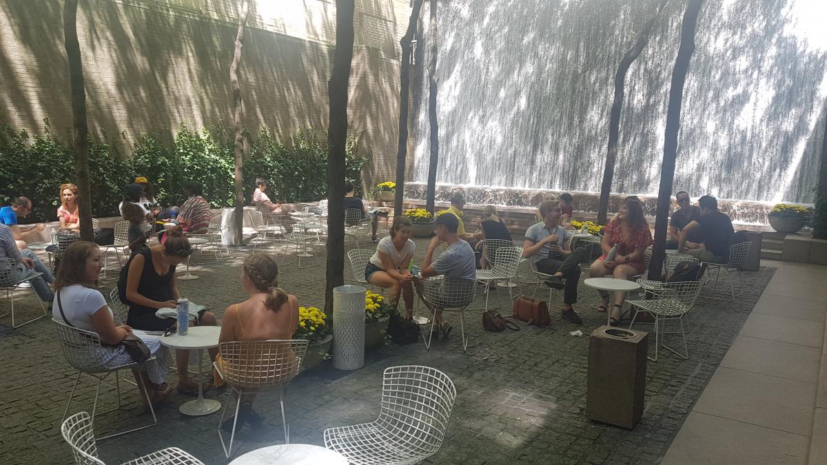 students sitting down resting at Paley Park