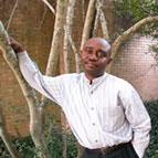 Forester Ndubisi leaning on a tree