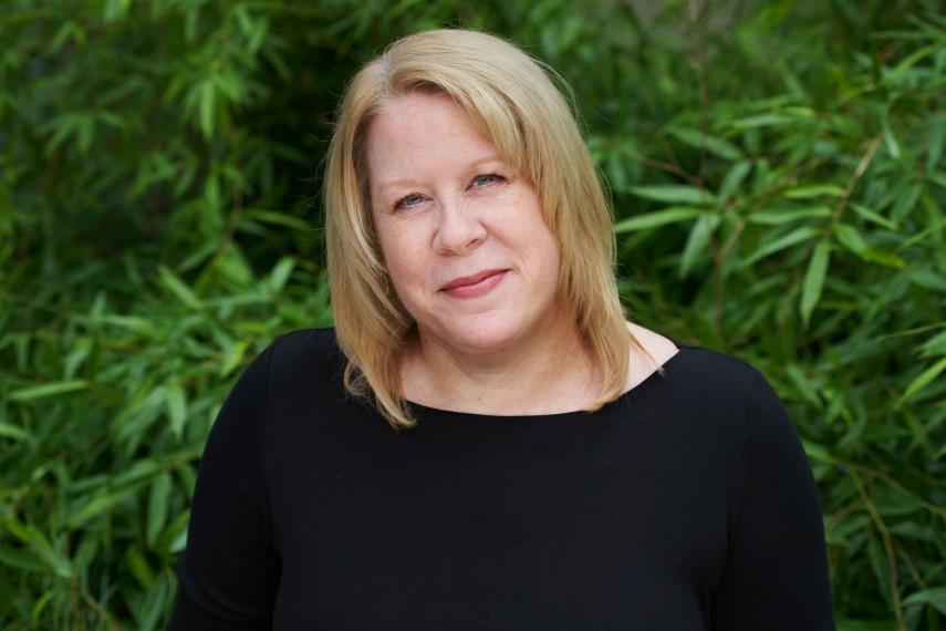 Head shot of Diana Foolen against greenery