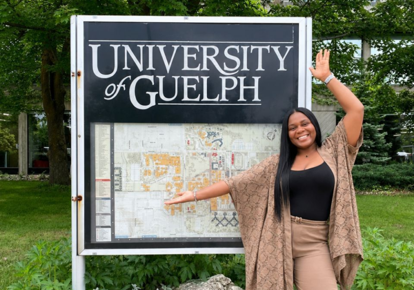 Lucy Chioma Aniagolu standing in front of outdoor UofG map
