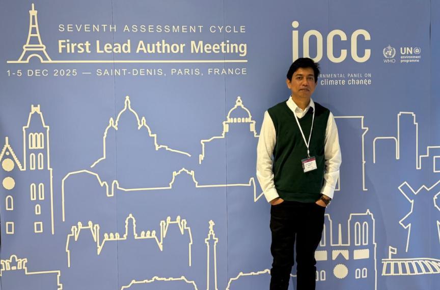 Dr. Mahatab Uddin standing in front of large IRCC conference poster