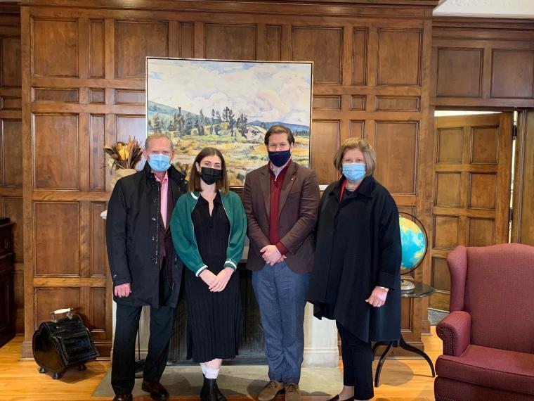 Charlotte Potter standing with the O'Born family in OAC Boardroom