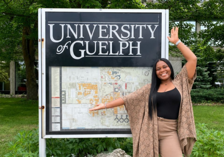 Lucy Chioma Aniagolu standing in front of outdoor UofG map