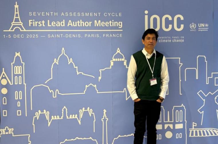 Dr. Mahatab Uddin standing in front of large IRCC conference poster